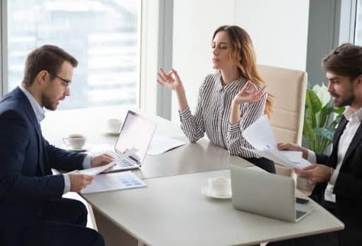 three real estate agents working at desk
