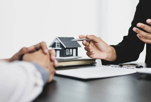 real estate deal with house on table