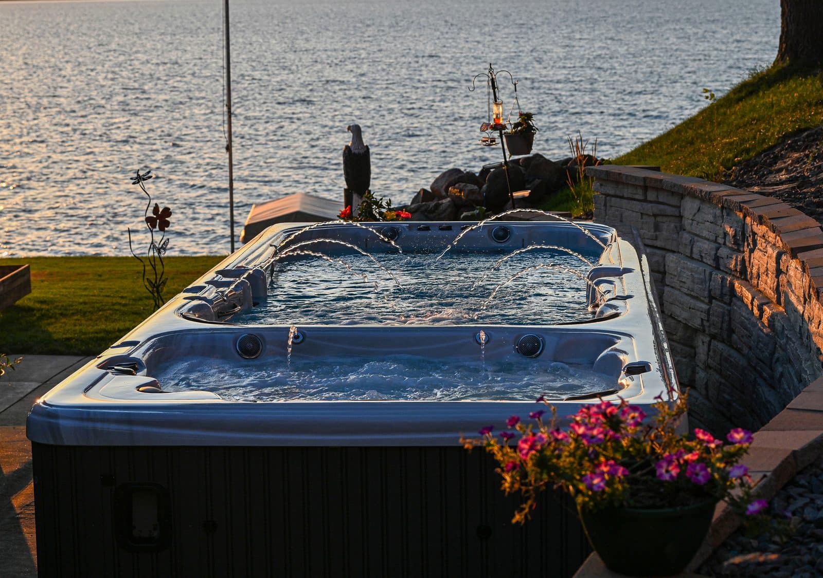 A Garden Leisure swim spa installed on a backyard patio at dusk