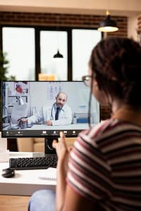 An online doctor speaking with a patient during a virtual visit.