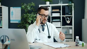 Medical professional speaking on the phone in a clinic office.