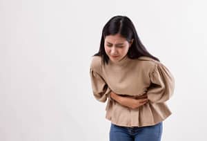 woman gripping stomach pain