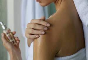 rubbing oil on skin
