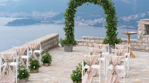 outdoor wedding with green arch