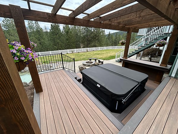 This design showcases the versatility of deck customization, featuring a stained pergola and a bar constructed with the same decking as the deck itself. The seating is crafted from 8x8 posts and deck boards, emphasizing seamless integration and functionality.