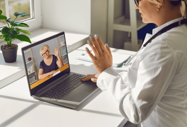 doctor talking to patient through laptop