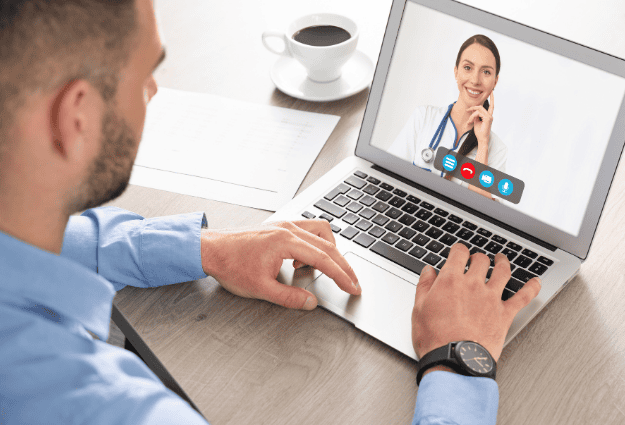 female doctor smiling on laptop