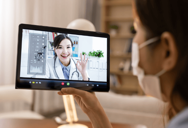 female doctor smiling on tablet