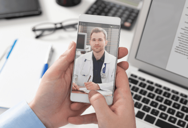 male telehealth doctor on phone video call