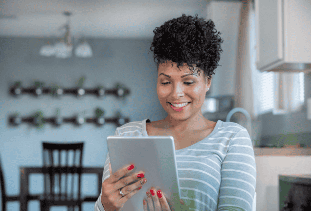 woman smiling on with tablet