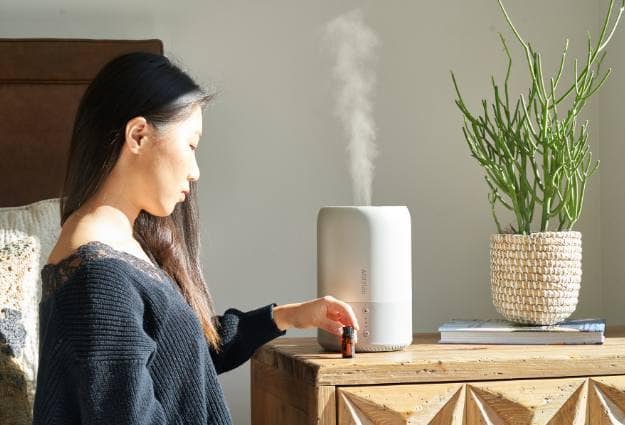 woman standing near humidifier