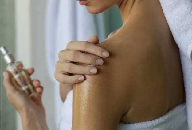 rubbing oil on skin