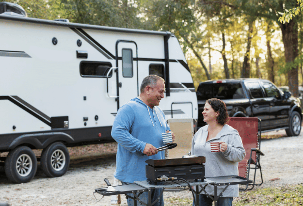 couple standing in front of RV