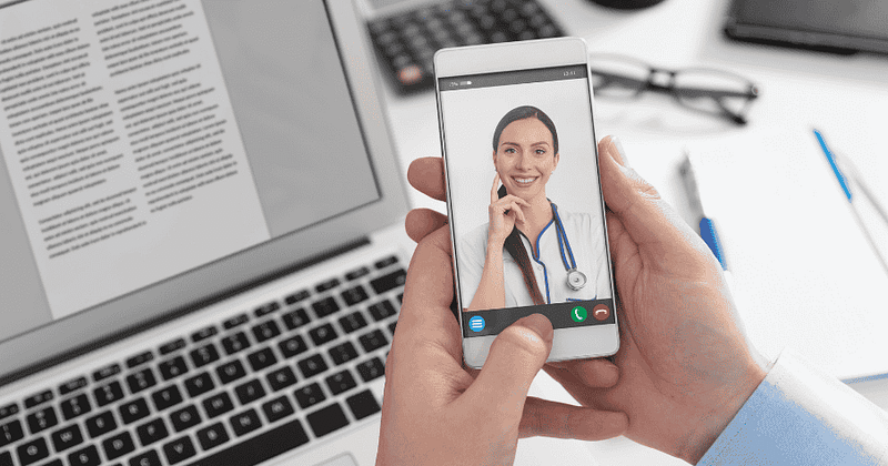 female doctor smiling on phone