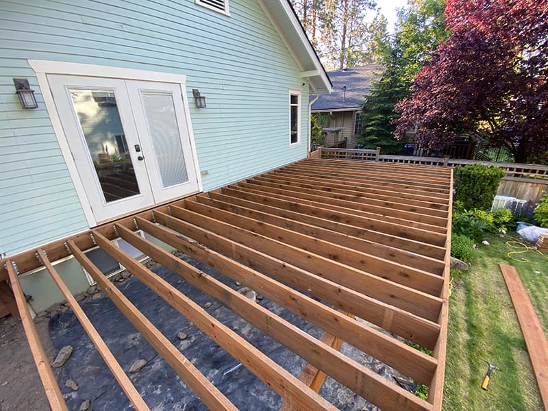 View from above of a recently framed pressure-treated deck in Spokane, Washington, elevated 4 feet off the ground.