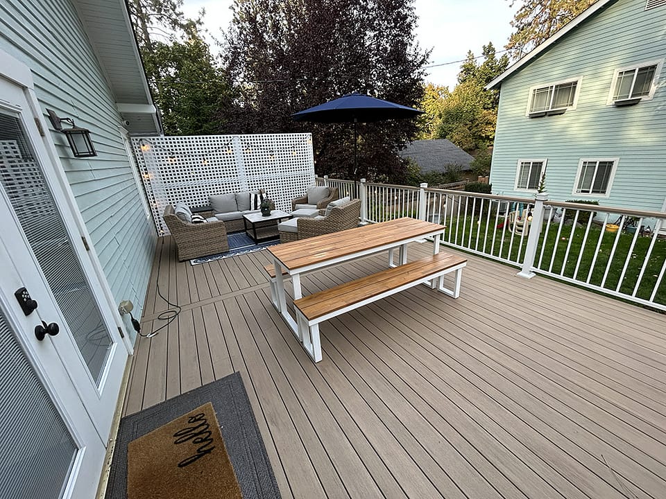 Back deck featuring a privacy wall, varied width decking, and an outdoor living room at the end.