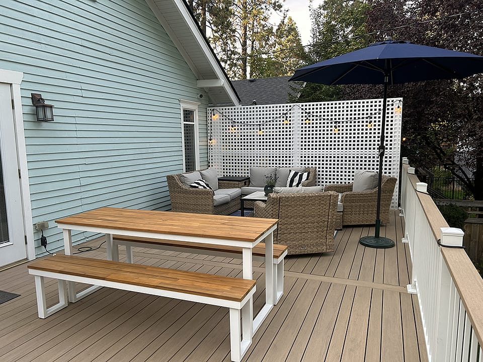 Beautiful back deck featuring a privacy wall and varied width decking for a unique design.