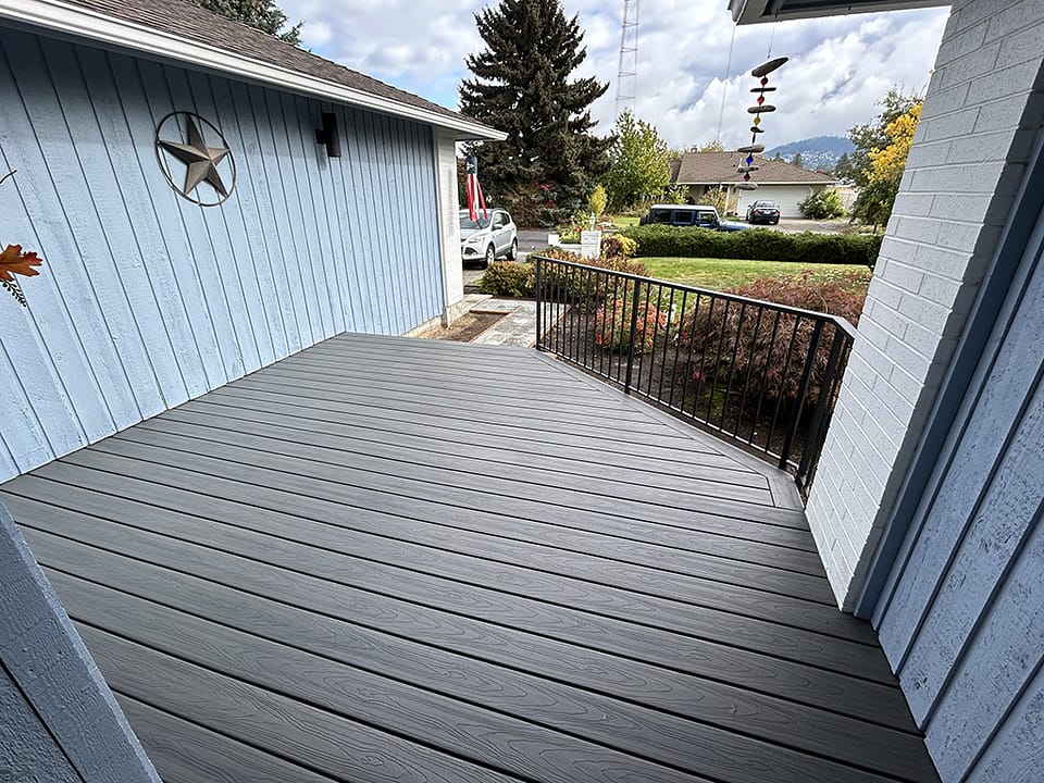 Gray front porch featuring a custom handrail.