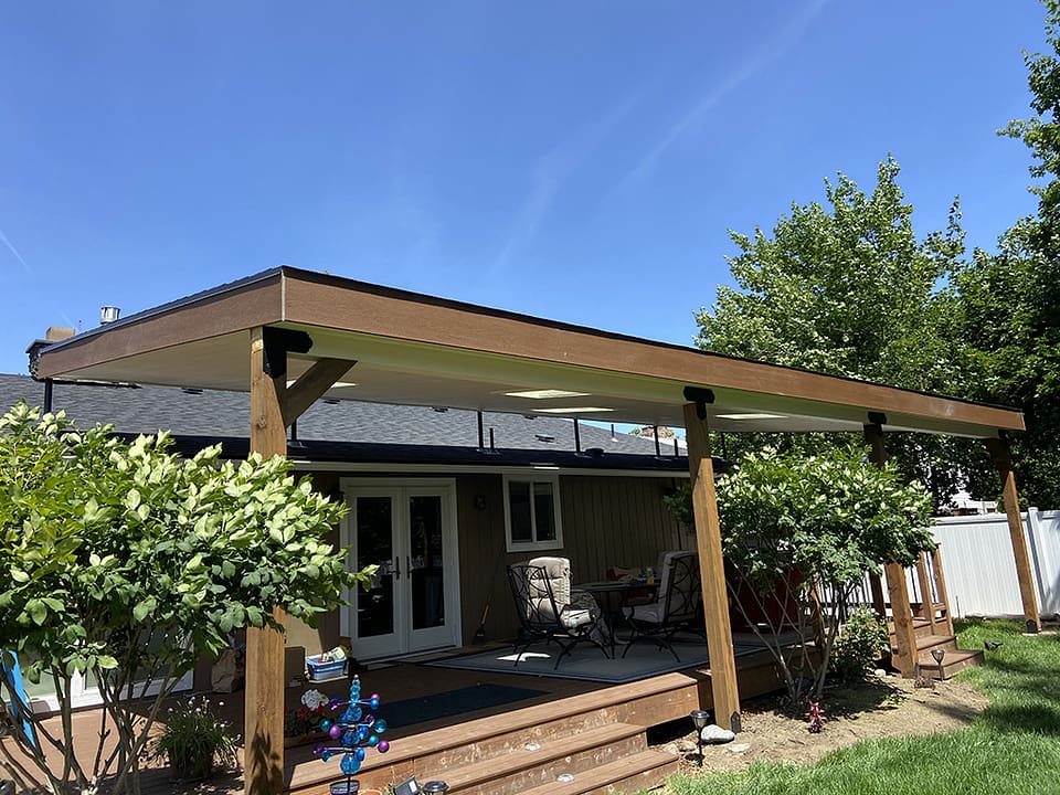 Lean-to roof covering a back composite deck.