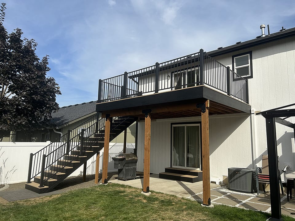 Modern deck elevated above a back sliding door, creating a striking outdoor feature.