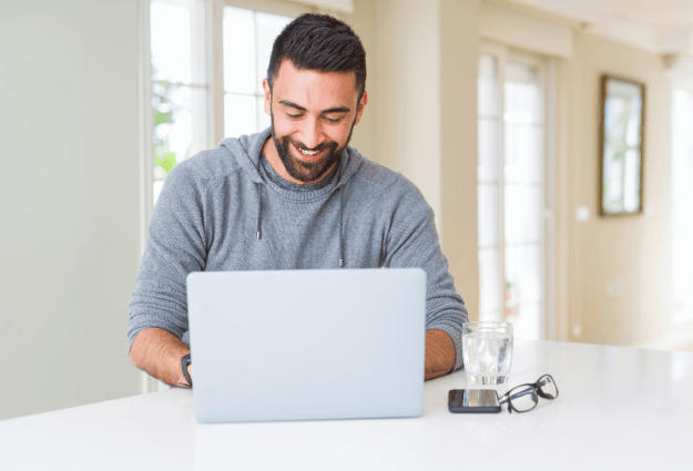 man smiling on laptop