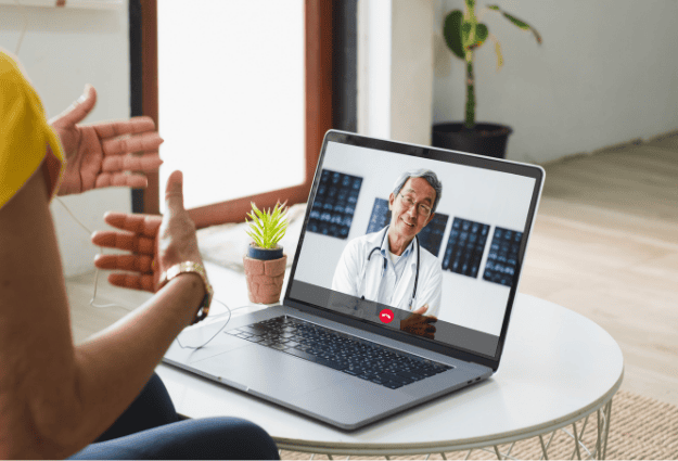 older doctor smiling through video call