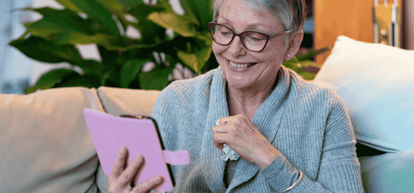 older woman smiling into phone