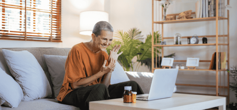 older woman smiling with laptop