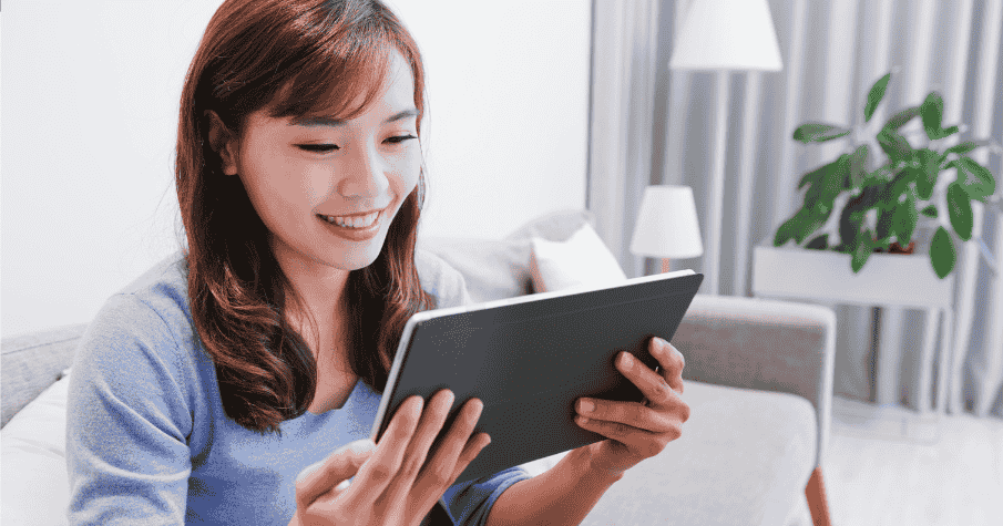 woman smiling holding tablet