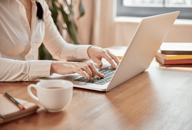 woman typing on laptop keyboard