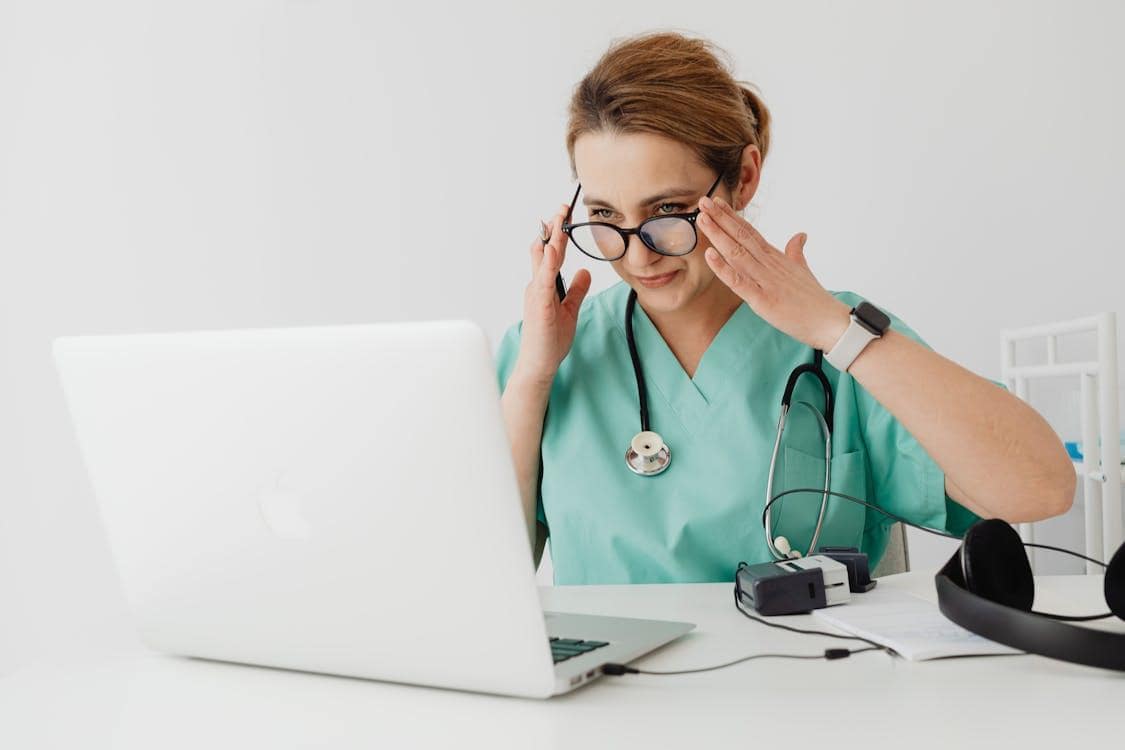 Doctor providing sinus infection consultation online using a laptop
