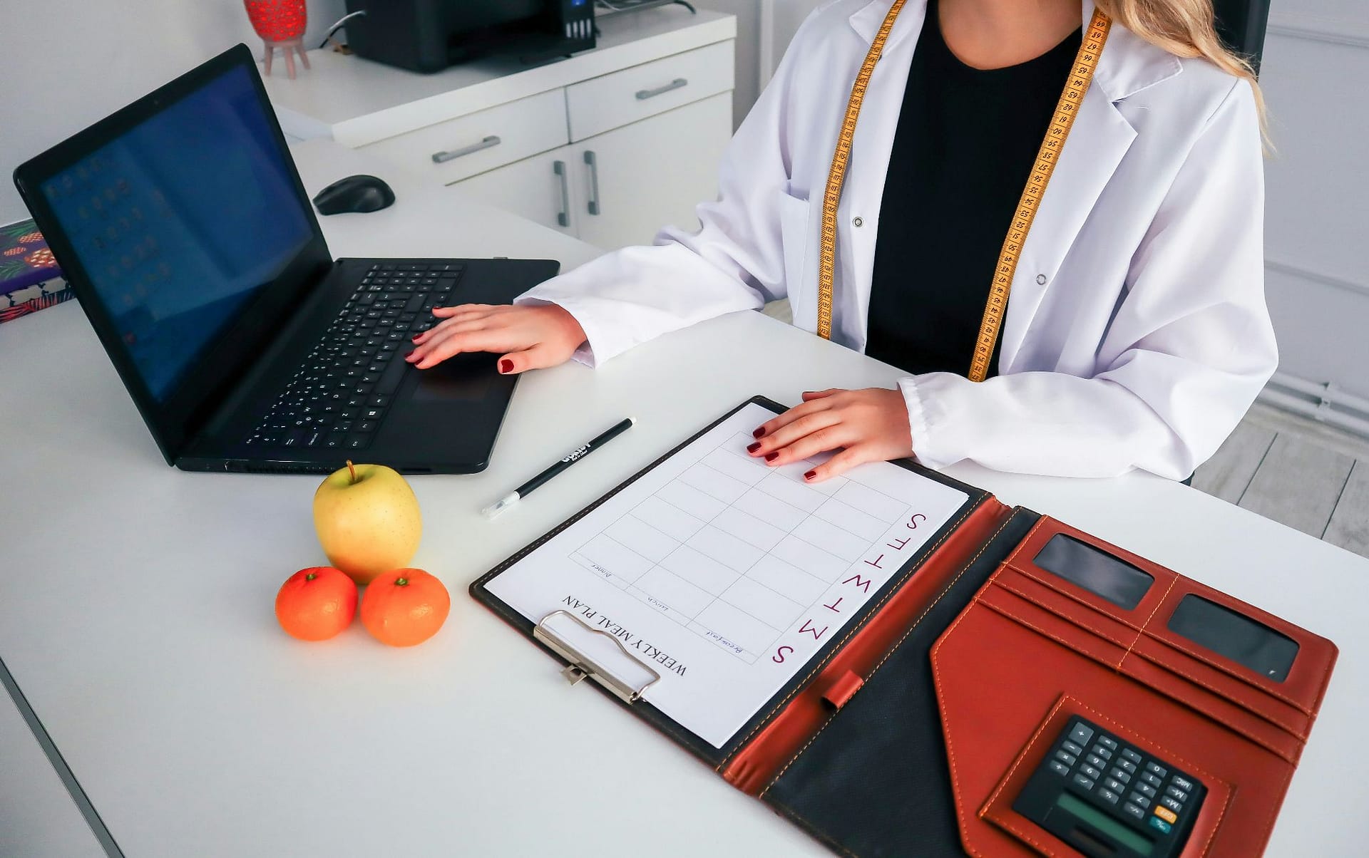 Medical professional in a white coat using a smartphone.